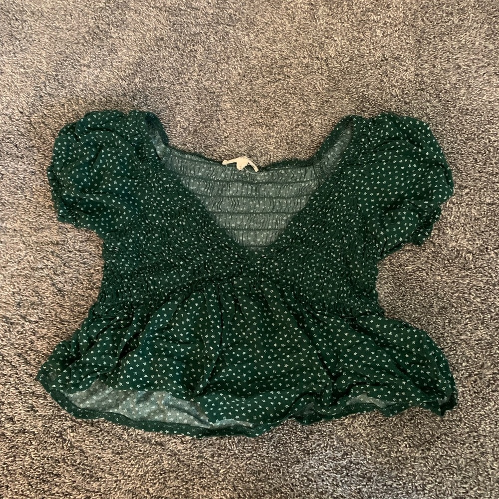 Green polka dotted shirt, very cropped and very cute!